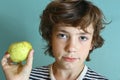 Preteen handsome boy hold green apple