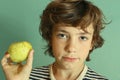 Preteen handsome boy hold green apple