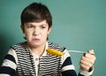 Preteen handsome boy with tablespoon of pumpkin soup Royalty Free Stock Photo