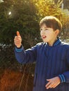 Preteen handsome boy toss a coin Royalty Free Stock Photo