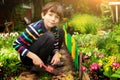 Preteen handsome boy work in the garden