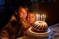 Preteen kid boy celebrating tenth birthday. little toddler girl, sister child and two kids boys brothers blowing together candles Royalty Free Stock Photo