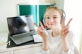 Preteen schoolgirl doing her homework with laptop computer at home. Child using gadgets to study. Online education and distance Royalty Free Stock Photo