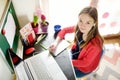 Preteen schoolgirl doing her homework with laptop computer at home. Child using gadgets to study. Online education and distance Royalty Free Stock Photo