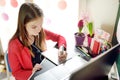 Preteen schoolgirl doing her homework with laptop computer at home. Child using gadgets to study. Online education and distance Royalty Free Stock Photo