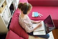 Preteen schoolgirl doing her homework with laptop computer at home. Child using gadgets to study. Online education and distance Royalty Free Stock Photo