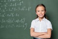 preteen schoolkid with crossed arms smiling