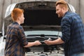 preteen son giving tool for repairing car Royalty Free Stock Photo