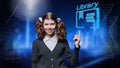 Preteen student girl looking at camera pointing with hand at online library Royalty Free Stock Photo