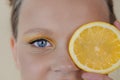 preteenager girl with lemon on yellow background. child with fruit