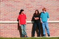 Preteens in front of brick wall