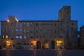 Pretorio Palace, Porcellino Tower and Priori Square in a quiet moment of the evening with the blue light, Volterra, Pisa, Tuscany