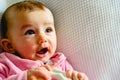 Pretty and adorable 6 month old baby girl smiling while playing with her mother