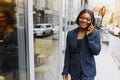 A pretty African american business woman talking on a cell phone at office building Royalty Free Stock Photo