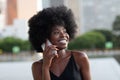 A pretty African american business woman talking on a cell phone at office building in the city Royalty Free Stock Photo