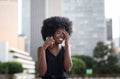 A pretty African american business woman talking on a cell phone at office building in the city Royalty Free Stock Photo