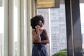 A pretty African american business woman talking on a cell phone at office building in the city Royalty Free Stock Photo