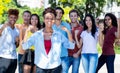 Pretty african american female student with group of cheering young adults Royalty Free Stock Photo