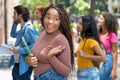 Pretty african american female university student with group of caucasian and hispanic young adults Royalty Free Stock Photo