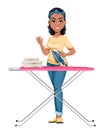 Pretty African American housewife ironing