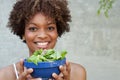 Pretty African American woman with salad