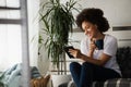 Pretty African American young woman reading an eBook at home Royalty Free Stock Photo