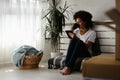 Pretty African American young woman reading an eBook at home Royalty Free Stock Photo