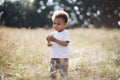 Pretty african boy eating cupcake on summer field Royalty Free Stock Photo