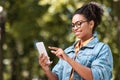 Pretty African Girl Using Mobile Phone Browsing Internet Walking Outside Royalty Free Stock Photo