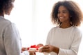 Happy mixed race daughter giving present to beloved mother Royalty Free Stock Photo