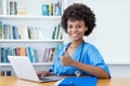 Pretty afro american nurse or medical student at computer Royalty Free Stock Photo