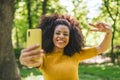 Pretty afro girl taking a selfie laughing. Royalty Free Stock Photo