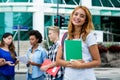 Pretty american female student with group of international people