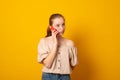 Pretty american girl has telephone conversation keeps smartphone near ear with gentle smile isolated