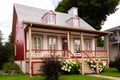 Pretty ancestral neoclassical house with metal sheet roof and red details