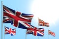 Pretty 5 flags of United Kingdom UK are waving on blue sky background - any feast flag 3d illustration Royalty Free Stock Photo