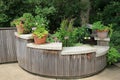 Pretty area of backyard, with garden shelves in curved wood structure