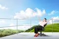 Pretty asian business woman sitting on the chair and relaxing on the terrace Royalty Free Stock Photo