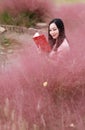Pretty Asian Chinese woman beautiful girl outdoor sit on grass lawn in a park garden feel carefree caucasian pasttime read book Royalty Free Stock Photo