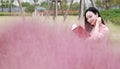 Pretty Asian Chinese woman beautiful girl outdoor sit on grass lawn in a park garden feel carefree caucasian pasttime read book Royalty Free Stock Photo