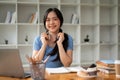 A pretty Asian female college student sits at her study table at home Royalty Free Stock Photo