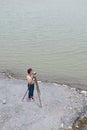 Pretty Asian female surveyor or engineer worker working with theodolite transit equipment.