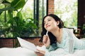 Pretty asian girl working on her school project at home Royalty Free Stock Photo