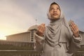 Pretty asian muslim girl in veil praying to god Royalty Free Stock Photo