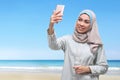 Pretty asian muslim woman posing taking selfie with mobile phone Royalty Free Stock Photo