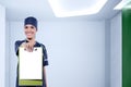 Pretty asian nurse with stethoscope showing blank clipboard for Royalty Free Stock Photo