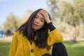 Pretty Asian woman in city park - lifestyle portrait of young beautiful and happy Korean girl sitting on green grass cheerful and Royalty Free Stock Photo