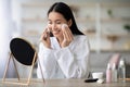 Pretty asian woman cleaning her face with toner Royalty Free Stock Photo