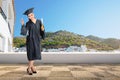 Pretty asian woman with graduation cap and diploma scroll Royalty Free Stock Photo