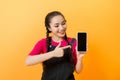 Pretty asian woman holding smartphone and pointing finger to the smartphone Royalty Free Stock Photo